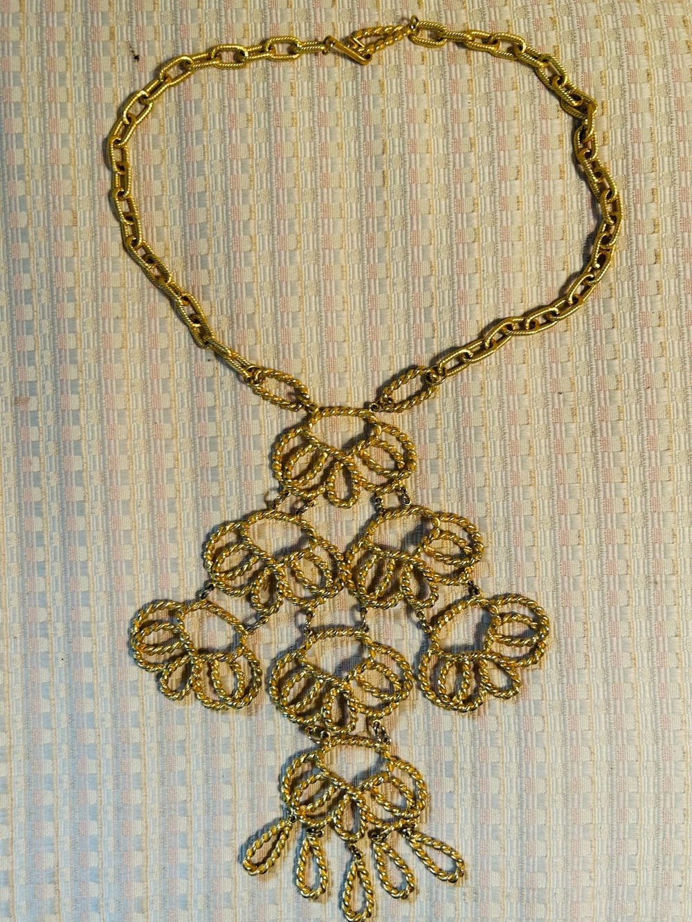 Vintage gold-tone statement necklace featuring an articulated, multi-tiered drop